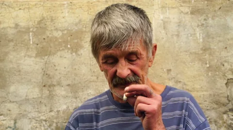 Footage a man at the age of smoking a cigarette. 4K Stock Footage