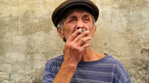 Footage a man at the age of smoking a cigarette. 4K Stock Footage