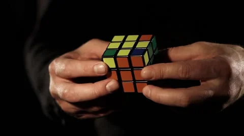 Footage of a man solving a Rubik´s cube, isolated on a black background Stock Footage 59823802