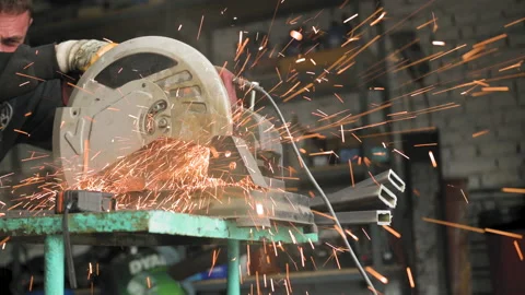 Footage of a man work with grinding a sheet of metal Stock Footage 153774152