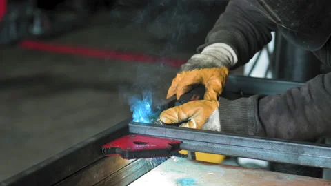 Footage of a man work with grinding a sheet of metal. Close-up. Slow motion Stock Footage 153789163