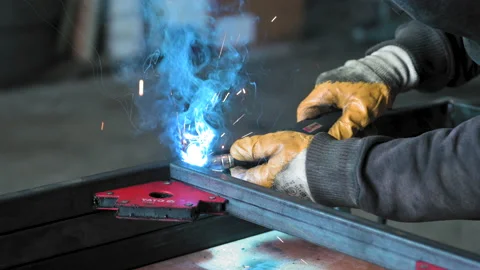 Footage of a man work with grinding a sheet of metal. Close-up Stock Footage 153789234
