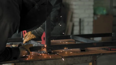 Footage of a man work with grinding a sheet of metal. Close-up Stock Footage 153789314