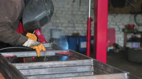 Footage of a man work with grinding a sheet of metal. Close-up Stock Footage 153789513