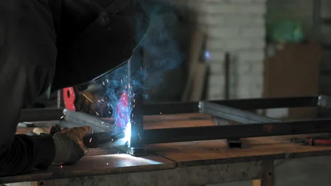 Footage of a man work with grinding a sheet of metal. Close-up Stock Footage 153789585