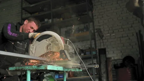 Footage of a man work with grinding a sheet of metal Stock Footage 153789722