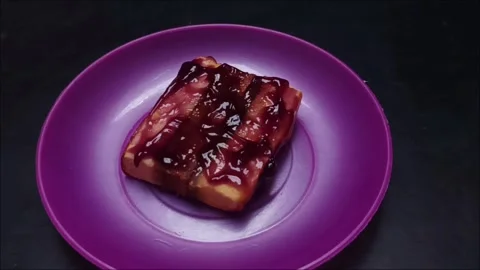 Footage of Mandarin Layer Cake Slices with Fruit Jam Topping on a Plate Stock Footage 327339474