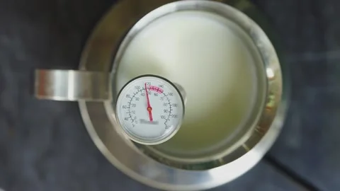 Footage of measuring increasing of milk temperature in stainless steel pot. Stock Footage 146788738