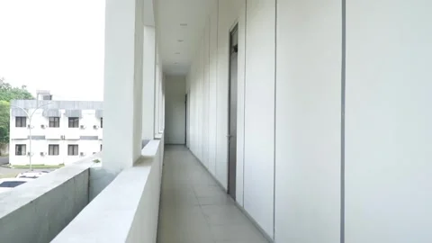 Footage Of Minimalist building corridor with long empty hallway, white concrete  Video stock 338046151