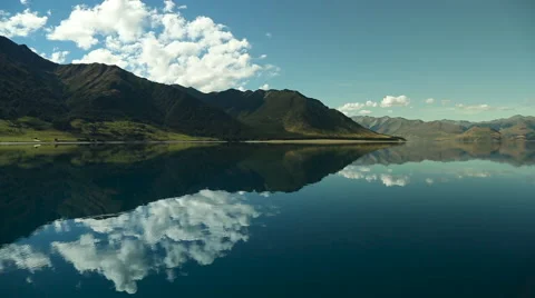Footage of mountains and clouds reflected in lake Video stock 55539620