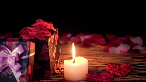 Footage move of gift boxes, petals and candle burning. Valentine day Stock Footage 101564431