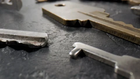 Footage movement over the keys lying on a black stone background. Stock Footage 211395243