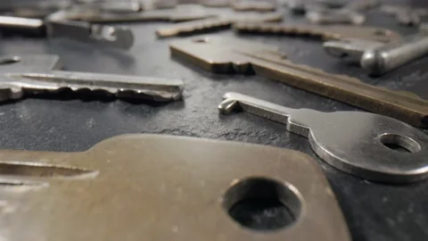 Footage movement over the keys lying on a black stone background. Stock Footage 211395899