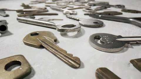 Footage movement over the keys lying on a white background. Stock Footage 211396244