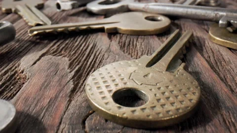 Footage movement over the keys lying on a old wooden background. Stock Footage 211396308