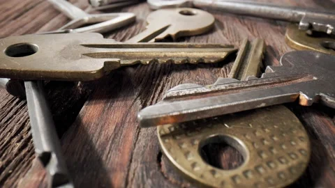 Footage movement over the keys lying on a old wooden background. Stock Footage 211396609