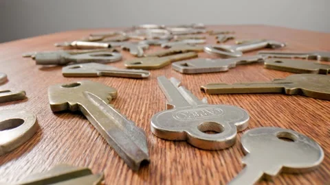 Footage movement over the keys lying on a old wooden background. Stock Footage 211396786