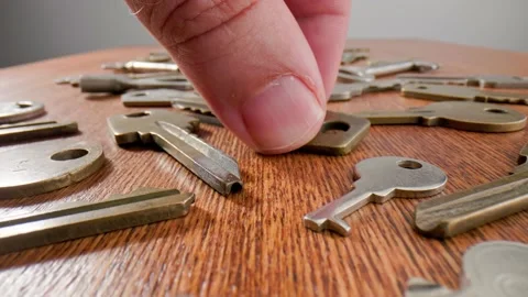 Footage movement over the keys lying on a old wooden background. Stock Footage 211396878