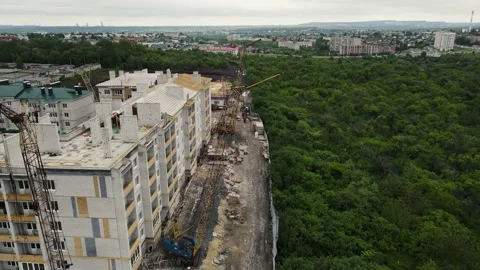 Footage of a moving drone along multi-storey buildings under construction Stock Footage 159827191