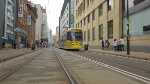Footage moving parallel along tram line with the Manchester Metrolink tram Stock Footage 93149045