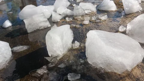 Footage of a person breaking off a large chunk of melting ice Stock Footage 333382846