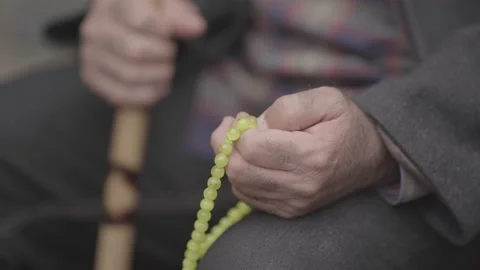 Footage of prayer beads being count in an old man's hand slog2 Stock Footage 141875682