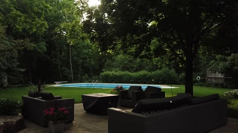Footage of a pristine backyard swimming pool in a luxury suburban home. Видео 90470624