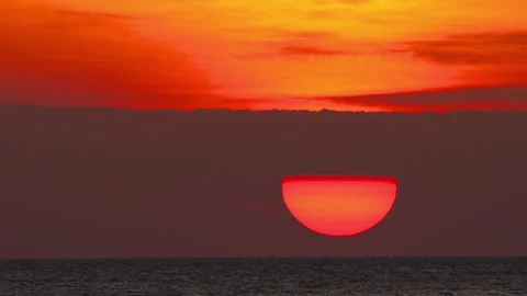 Footage of red sun setting over sea 스톡 동영상 327730420