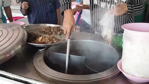 Footage. Restaurant chef scooping, noodle soup and meatballs, put in hot bag Stock Footage 172228076