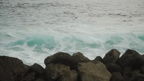 A footage of the sea whose waves beat against the stones on the shore. Stock Footage 154160317