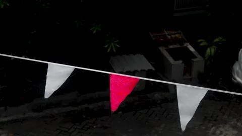 This footage shows a string of alternating red and white triangular flags h.. Stock Footage 320995893