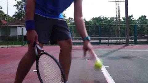 Footage Slow Motion: Man bouncing ball before serving on tennis court Stock Footage 206993957