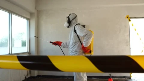 Footage Slow Motion: Specialists in protective suit disinfecting coronavirus Stock Footage 148098342