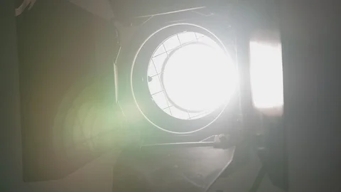 Footage of studio light being turned on and off. Floodlight flashes Stock Footage 129846669
