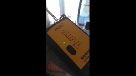 Footage of testing LAN cables with a LAN tester Stock Footage 310457556