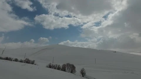 Footage of thick white clouds racing across the blue sky, stock footage. Stock Footage 304829367