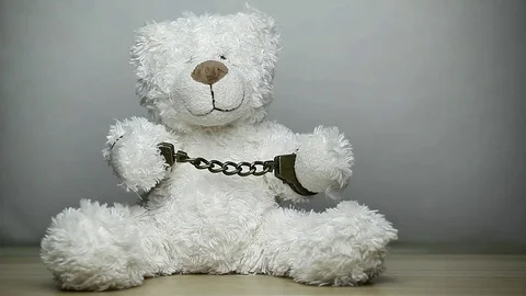 Footage of toy bear handcuff Stock Footage 129050037
