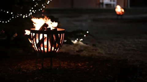 Footage of two fire pits with flames dancing, set up at the Christmas market. Stock Footage 258440013