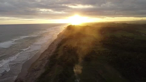Footage using a drone on the beach at sunset Video stock 274326298