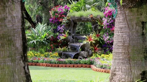 Footage waterfall flows in cozy home flower garden. Stock Footage