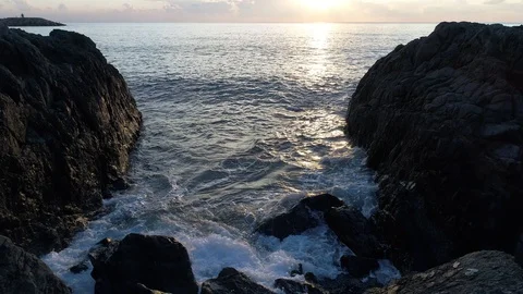 A footage of waves that lap up against the rocks via drone Stock Footage 100728580
