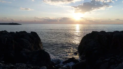A footage of waves that lap up against the rocks via drone Stock Footage 100728659