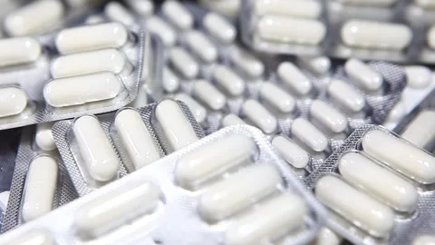 Footage of white pills background Stock Footage 256971667