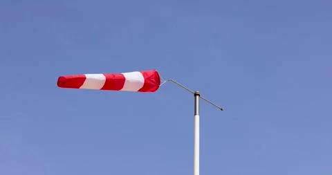 Footage of a wind sock with wind blowing through the sleeve on a clear blue.. Stock Footage 270496173