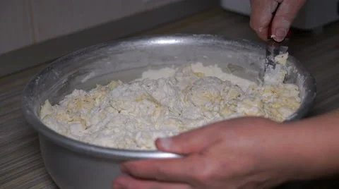 Footage woman kneads dough in a dish. 4K Stock Footage