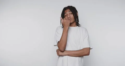 Footage of young man displaying confidence with a casual pose, highlighting.. Stock Footage 317631653