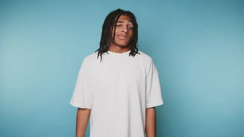 Footage of young man with dreadlocks stands displaying a calm and casual de.. Stock Footage 316922766