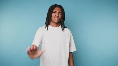 Footage of young man looking perplexed while gesturing with his hand, captu.. Stock Footage 314522382