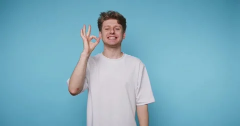 Footage of young man making an OK gesture with his hand, showing a cheerful.. Stock Footage 314773418