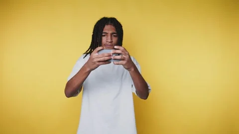 Footage of young man, showcasing focus, is intensely engaged in a game on h.. Stock Footage 314522409